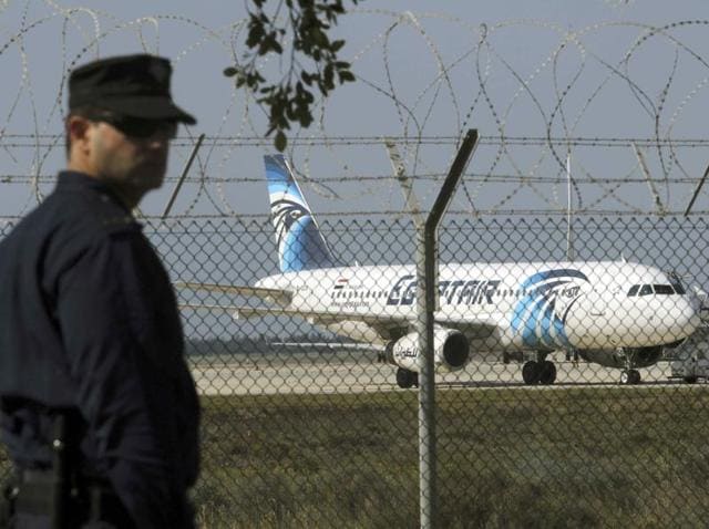 A policeman stands guard at Larnaca Airport near a hijacked Egyptair A320 plane.(REUTERS)