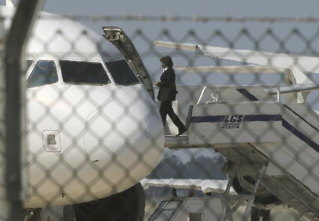 An official boards the hijacked plane. The plane is parked at an apron at Larnaca airport. The hijacker asked police to back away from the aircraft, Cyprus broadcaster CYBC said. (REUTERS)