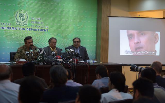 Pakistani Lieutenant General Asim Bajwa (L) speaks with media representatives. (AFP)