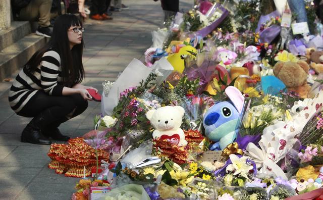 A woman visits a makeshift memorial for a girl who was attacked to death Monday by a knife-wielding assailant outside a subway station in Taipei, Taiwan. (AP) A woman visits a makeshift memorial for a girl who was attacked to death Monday by a knife-wielding assailant outside a subway station in Taipei, Taiwan. (AP)