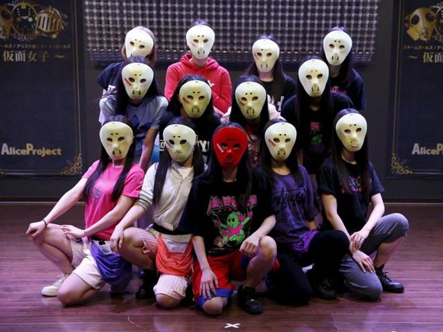 Members of Japanese idol group Kamen Joshi (Masked Girls) pose for a photo after a rehearsal for a concert at their theatre in Tokyo's Akihabara district. (REUTERS) 
