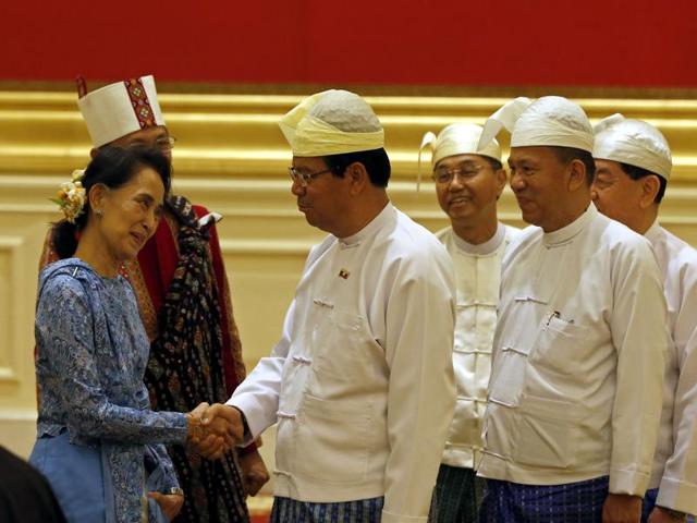 Newly sworn-in Myanmar foreign minister Aung San Suu Kyi (centre) and Myanmar vice president Henery Van Thio (right) leave after the handover ceremony at the presidential palace in Naypyidaw on Wednesday.(AFP) Newly sworn-in Myanmar foreign minister Aung San Suu Kyi (centre) and Myanmar vice president Henery Van Thio (right) leave after the handover ceremony at the presidential palace in Naypyidaw on Wednesday.(AFP)