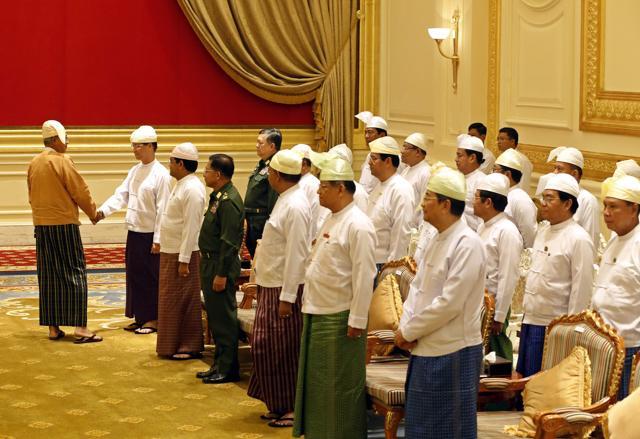 Myanmar's new President Htin Kyaw (L) greets members of the old cabinet during the handover ceremony at the presidential palace in Naypyidaw. (AFP) Myanmar's new President Htin Kyaw (L) greets members of the old cabinet during the handover ceremony at the presidential palace in Naypyidaw. (AFP)