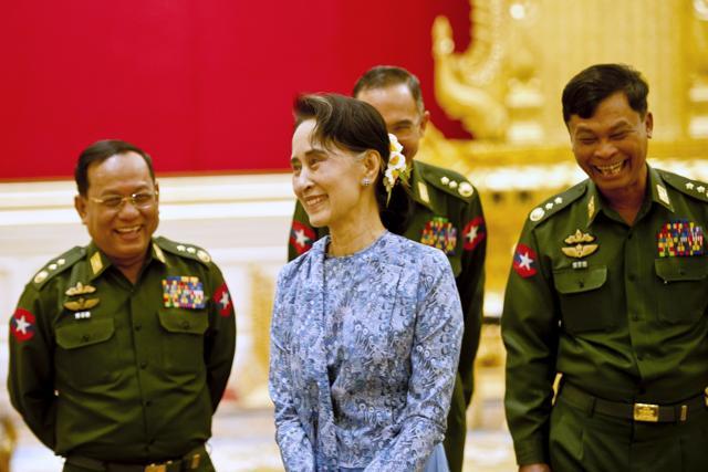 Myanmar's NLD party leader Aung San Suu Kyi smiles with army members during the handover ceremony of outgoing President Thein Sein and new President Htin Kyaw. (REUTERS) Myanmar's NLD party leader Aung San Suu Kyi smiles with army members during the handover ceremony of outgoing President Thein Sein and new President Htin Kyaw. (REUTERS)