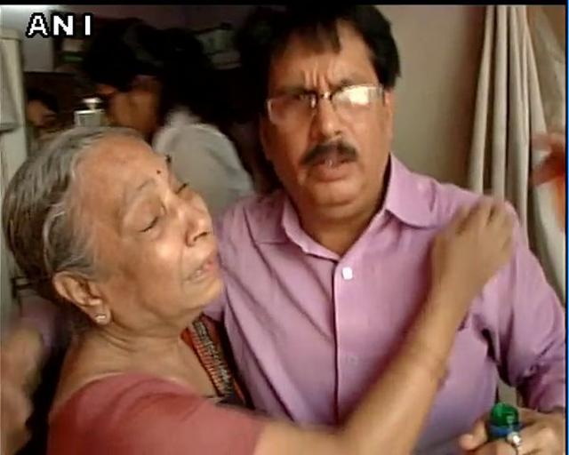 A man comforts an elderly woman whose relative is feared trapped under the collapsed bridge. (ANI) A man comforts an elderly woman whose relative is feared trapped under the collapsed bridge. (ANI)