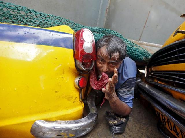 A man is seen trapped amid the debris of an under-construction flyover after it collapsed in Kolkata. (Reuters Photo) A man is seen trapped amid the debris of an under-construction flyover after it collapsed in Kolkata. (Reuters Photo)
