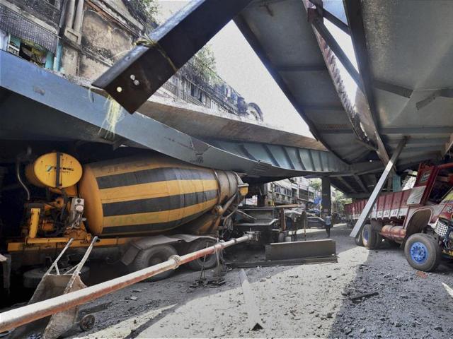 Vehicles are seen trapped under a partially collapsed overpass in Kolkata. (PTI via AP Photo) Vehicles are seen trapped under a partially collapsed overpass in Kolkata. (PTI via AP Photo)