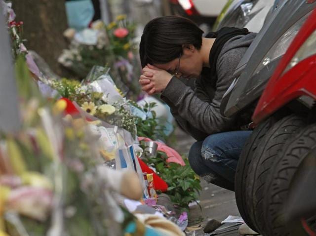 In this Tuesday, March 29, 2016 file photo, a woman prays in front of a makeshift memorial offered with flowers and stuffed animals for a girl who was killed Monday by a knife-wielding assailant outside a subway station in Taipei, Taiwan. (AP Photo) In this Tuesday, March 29, 2016 file photo, a woman prays in front of a makeshift memorial offered with flowers and stuffed animals for a girl who was killed Monday by a knife-wielding assailant outside a subway station in Taipei, Taiwan. (AP Photo)