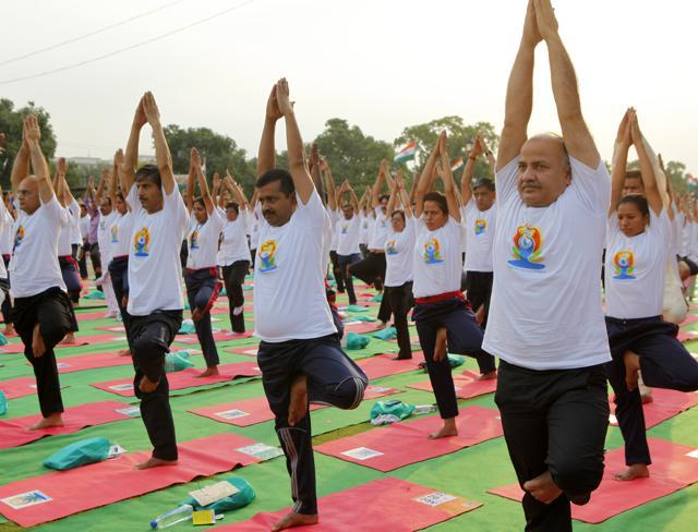 Chief Minister of Delhi Arvind Kejriwal with Deputy Chief Minister Manish Sisodia performing yoga at Rajpath during the International Yoga Day celebrations in New Delhi, June 21, 2015 (Arvind Yadav / HT Photo)