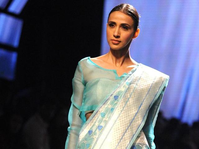 A model sports a Swati & Sunaina creation, who explored an organic line infused with elements from the life of mythological character Radha. Their collection is a sensuous line of gossamer creations handloomed with precision. (AFP) A model sports a Swati & Sunaina creation, who explored an organic line infused with elements from the life of mythological character Radha. Their collection is a sensuous line of gossamer creations handloomed with precision. (AFP)