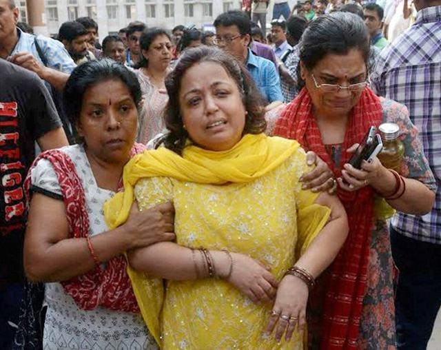 A woman comforts a relative of a person injured in the flyover collapse. (PTI) A woman comforts a relative of a person injured in the flyover collapse. (PTI)