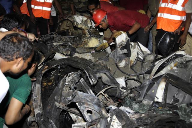 Rescue workers search for bodies inside a mangled car recovered from a partially collapsed overpass in Kolkata, India, Thursday, March 31, 2016. (AP) Rescue workers search for bodies inside a mangled car recovered from a partially collapsed overpass in Kolkata, India, Thursday, March 31, 2016. (AP)
