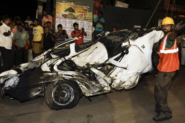 An Indian rescue worker gestures beside a mangled car recovered from a partially collapsed overpass in Kolkata, India, Thursday, March 31, 2016. (AP) An Indian rescue worker gestures beside a mangled car recovered from a partially collapsed overpass in Kolkata, India, Thursday, March 31, 2016. (AP)
