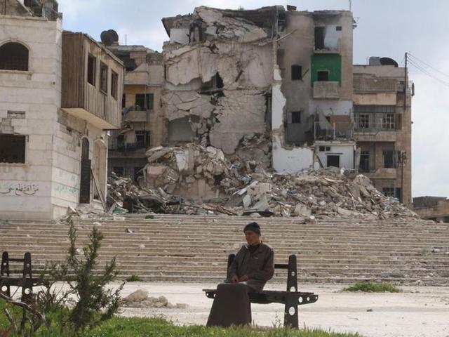 A man sits in front of a damaged building in a rebel held area of Aleppo, Syria. (REUTERS) A man sits in front of a damaged building in a rebel held area of Aleppo, Syria. (REUTERS)