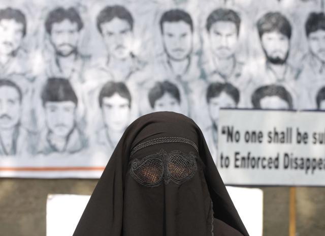 A Kashmiri woman stands in front of a poster of disappeared persons in Srinagar. (Waseem Andrabi/HT File Photo) A Kashmiri woman stands in front of a poster of disappeared persons in Srinagar. (Waseem Andrabi/HT File Photo)