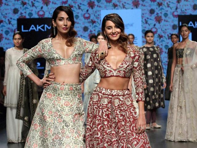Singer and Bollywood actress Monica Dogra and  TV celebShibani Dandekar showcase a creation by designer Payal Singhal . (PTI) 