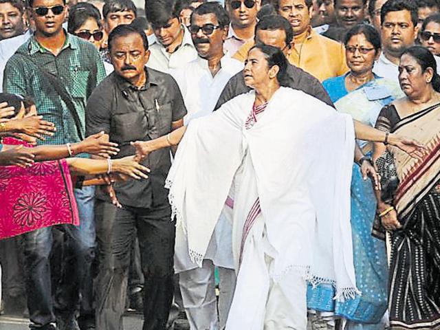 Trinamool president and West Bengal chief minister Mamata Banerjee greets supporters at a campaign rally in Bankura on Sunday.(Subhankar Chakraborty/HT Photo)