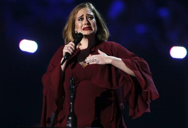 Adele reacts as she accepts the global success award at the BRIT Awards at the O2 arena in London, February 24, 2016. (Reuters)