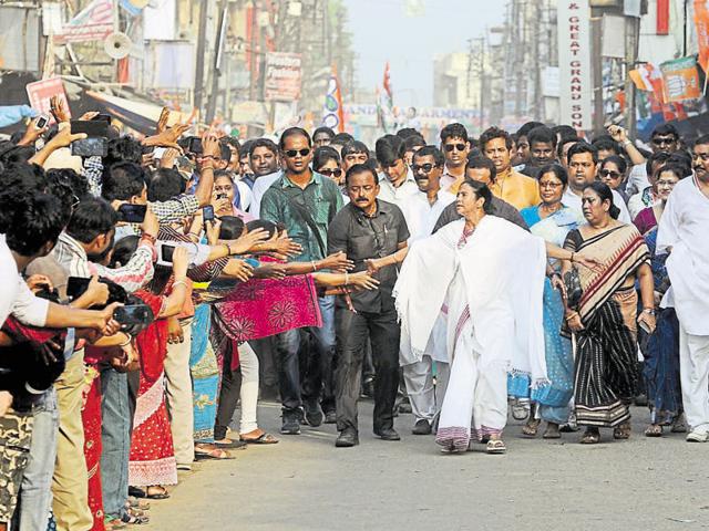 Kolkata: TMC workers carrying giant hoardings of West Bengal CM‘Syndicate’ is an extortion racket that runs in areas where real estate is witnessing a boom. Unemployed men backed by the ruling party use the clout and the threat of violence to force contractors into buying inferior building materials from them at a premium.(PTI)