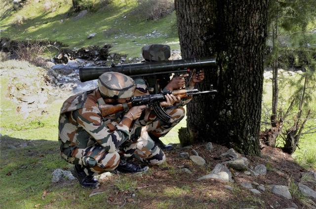 Army personnel taking position at the site where militants were hiding during an encounter at Lolaab area of Kupwara district of north Kashmir on Tuesday. (PTI) Army personnel taking position at the site where militants were hiding during an encounter at Lolaab area of Kupwara district of north Kashmir on Tuesday. (PTI)