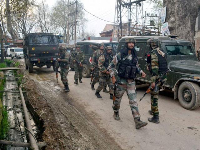 Army personnel moving towards the house where militants were hiding during an encounter at Gadoora village of Pulwama district of South Kashmir on Tuesday. (PTI) Army personnel moving towards the house where militants were hiding during an encounter at Gadoora village of Pulwama district of South Kashmir on Tuesday. (PTI)