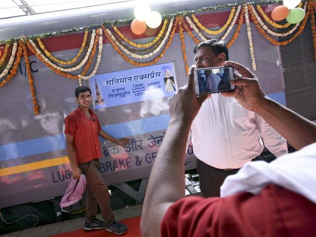 As the train was due for the flag-off at the Hazrat Nizamuddin Railway Station in New Delhi on Tuesday, excited porters and passengers at the platform posed with the newest offering from Indian Railways. (Arun Sharma / HT Photo)