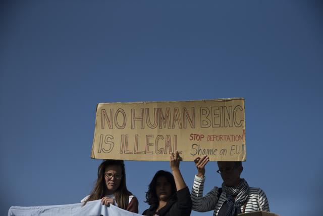 Protesters hold a banner as they demonstrate against deportations planned at the port of Mytilini, Lesbos island, Greece. (AP Photo) Protesters hold a banner as they demonstrate against deportations planned at the port of Mytilini, Lesbos island, Greece. (AP Photo)
