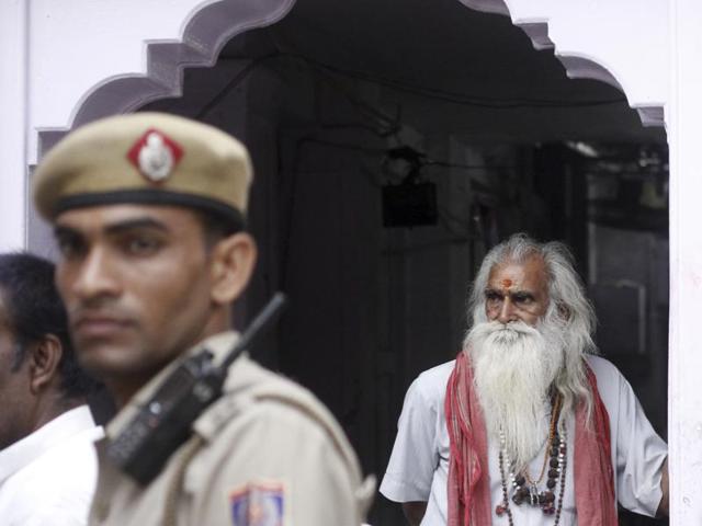 A priest looks on as the authorities remove an illegal structure in Purani Dilli area. (Sanchit Khanna/HT Photo) 