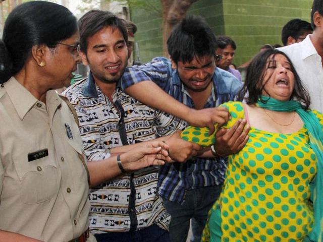 Grieving family members of Himanshi Kashyap (inset) , daughter-in-law of BSP Rajya Sabha member Narendra Kashyap, in Ghaziabad on Wednesday. (PTI Photo) Grieving family members of Himanshi Kashyap (inset) , daughter-in-law of BSP Rajya Sabha member Narendra Kashyap, in Ghaziabad on Wednesday. (PTI Photo)