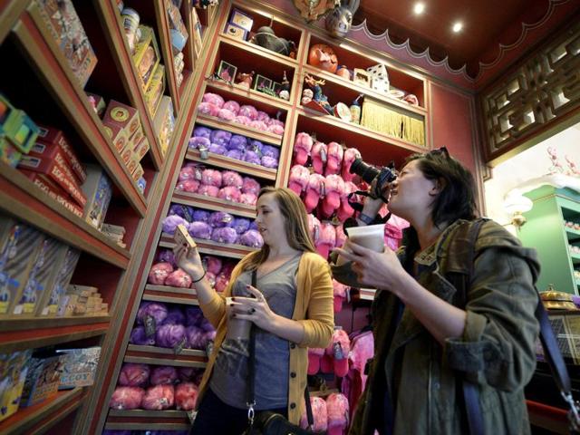 Guests look at a display of candy inside the Honeydukes sweets shop in Hogsmeade Village during a soft opening and media tour of The Wizarding World of Harry Potter theme park at the Universal Studios Hollywood in Los Angeles. (REUTERS)