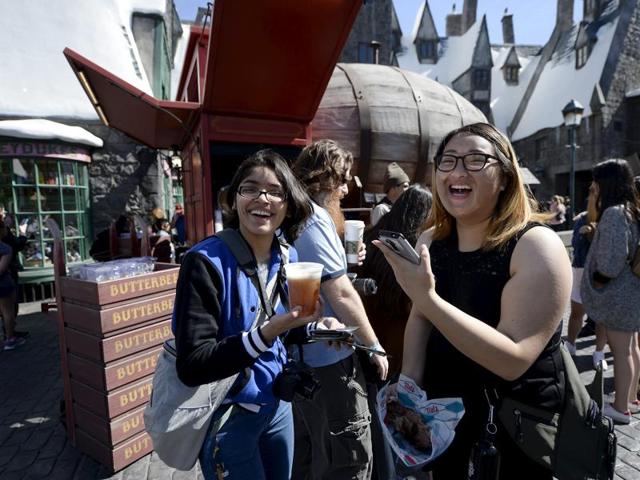Guests try out Butterbeer served from a large barrel shaped Butterbeer cart in Hogsmeade Village during a soft opening and media tour of The Wizarding World of Harry Potter theme park at the Universal Studios Hollywood in Los Angeles. (REUTERS)