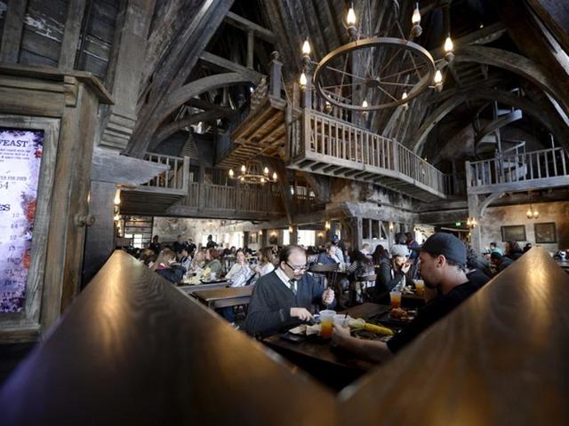 Guests eat lunch inside Three Broomsticks, an aged rustic tavern, in Hogsmeade Village during a soft opening and media tour of The Wizarding World of Harry Potter theme park at the Universal Studios Hollywood in Los Angeles, California. (REUTERS)