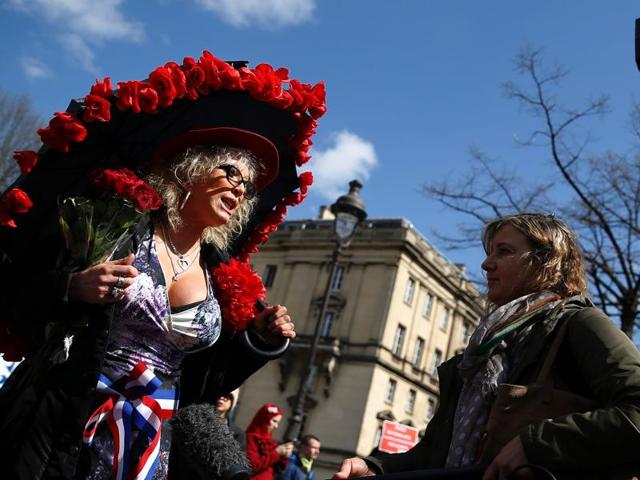 Protesters hold a banner reading "Don't liberate me, I'll take care of it myself!" during a demonstration by sex workers and supporters near the French National Assembly in Paris on Wednesday. (AFP) Protesters hold a banner reading "Don't liberate me, I'll take care of it myself!" during a demonstration by sex workers and supporters near the French National Assembly in Paris on Wednesday. (AFP)