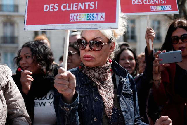 A sex worker holds a sign during a protest against new bill against prostitution and sex trafficking in Paris on Wednesday. (AP) A sex worker holds a sign during a protest against new bill against prostitution and sex trafficking in Paris on Wednesday. (AP)