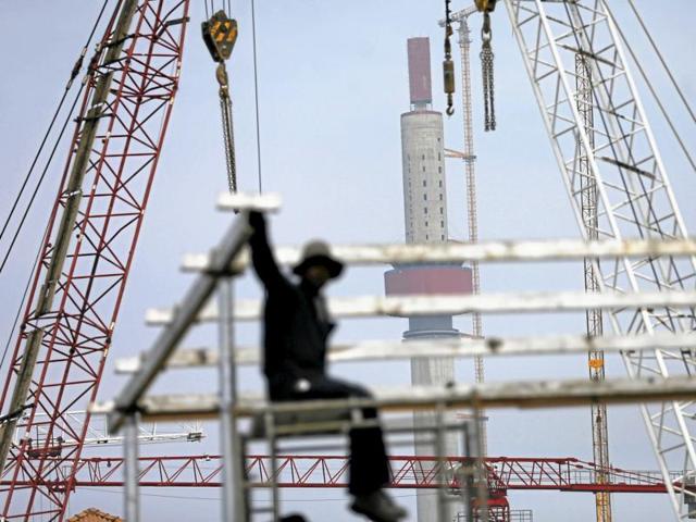 A worker looks on as the Lotus Tower construction site, backed by Chinese investment, is seen behind him in Colombo. (REUTERS File Photo) A worker looks on as the Lotus Tower construction site, backed by Chinese investment, is seen behind him in Colombo. (REUTERS File Photo)