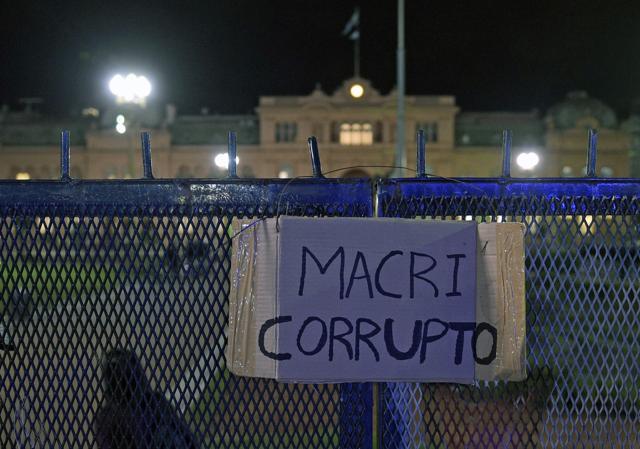 View of a sign reading "Macri corrupt" pasted on the fence of the Government Palace in Buenos Aires during a demonstration against Argentine President Mauricio Macri on Thursday after a prosecutor opened an investigation on his offshore financial dealings leaked in the Panama Papers. (AFP) View of a sign reading "Macri corrupt" pasted on the fence of the Government Palace in Buenos Aires during a demonstration against Argentine President Mauricio Macri on Thursday after a prosecutor opened an investigation on his offshore financial dealings leaked in the Panama Papers. (AFP)