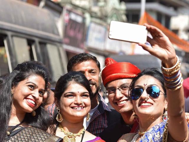 Youngsters take selfie duing Gudi Padwa procession at Girgaum in Mumbai on Friday. (Pratham Gokhale/ Hindustan Times)