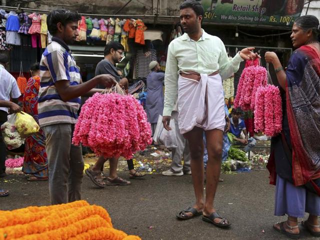 A shopper bargains with flower vendors at a wholesale market on the occasion of Ugadi in Bangalore. (AP)