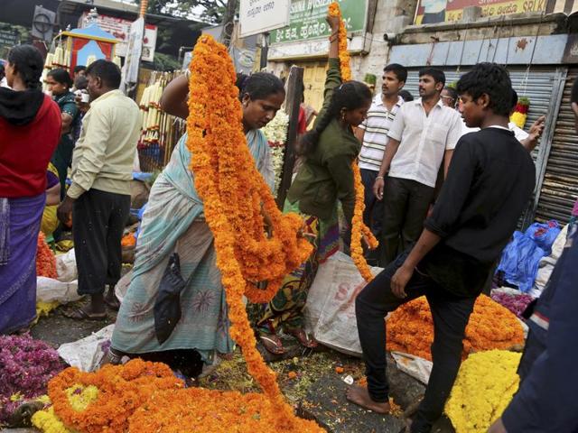 Flower vendors arrange flowers at a wholesale market on the occasion of Ugadi in Bangalore. (AP)