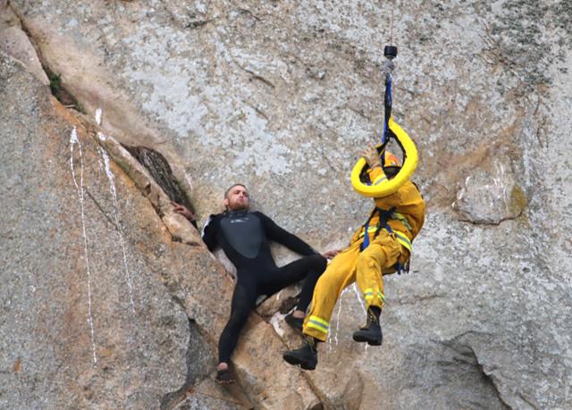 He had scaled the rock to make an Internet proposal to his girlfriend - who said yes - but then got stuck on a ledge and couldn't get down. (AP) He had scaled the rock to make an Internet proposal to his girlfriend - who said yes - but then got stuck on a ledge and couldn't get down. (AP)