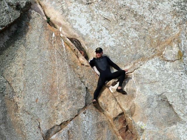 In this photo provided by Bob Isenberg, Michael Banks is stranded on a ledge some 80 feet off the ground on Morro Rock, e a landmark in Morro Bay. (AP) In this photo provided by Bob Isenberg, Michael Banks is stranded on a ledge some 80 feet off the ground on Morro Rock, e a landmark in Morro Bay. (AP)