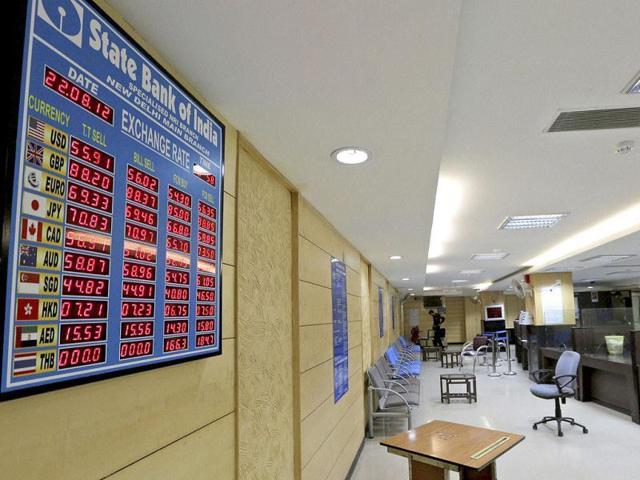 An electronic board displays currency exchange rates in a State Bank of India branch.(HT Photo)