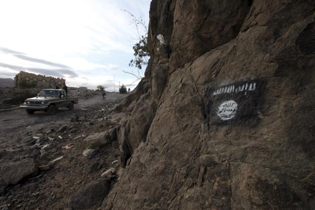Shi'ite Houthi rebels drive a patrol truck past an Ansar al-Sharia flag painted on the side of a hill, along a road in Almnash, the main stronghold of Ansar al-Sharia, the local wing of Al Qaeda in the Arabian Peninsula (AQAP) in Rada, Yemen. (REUTERS) Shi'ite Houthi rebels drive a patrol truck past an Ansar al-Sharia flag painted on the side of a hill, along a road in Almnash, the main stronghold of Ansar al-Sharia, the local wing of Al Qaeda in the Arabian Peninsula (AQAP) in Rada, Yemen. (REUTERS)