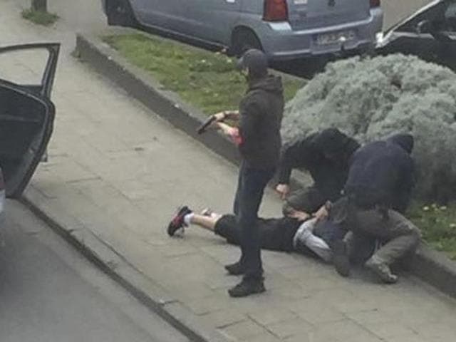 Police officers detain a suspect during a raid in which fugitive Mohamed Abrini was arrested in Anderlecht, near Brussels, Belgium, April 8, 2016 in this still image taken from video. Abrini is among 4 persons who have been held on terror charges by Belgium . (REUTERS) Police officers detain a suspect during a raid in which fugitive Mohamed Abrini was arrested in Anderlecht, near Brussels, Belgium, April 8, 2016 in this still image taken from video. Abrini is among 4 persons who have been held on terror charges by Belgium . (REUTERS)