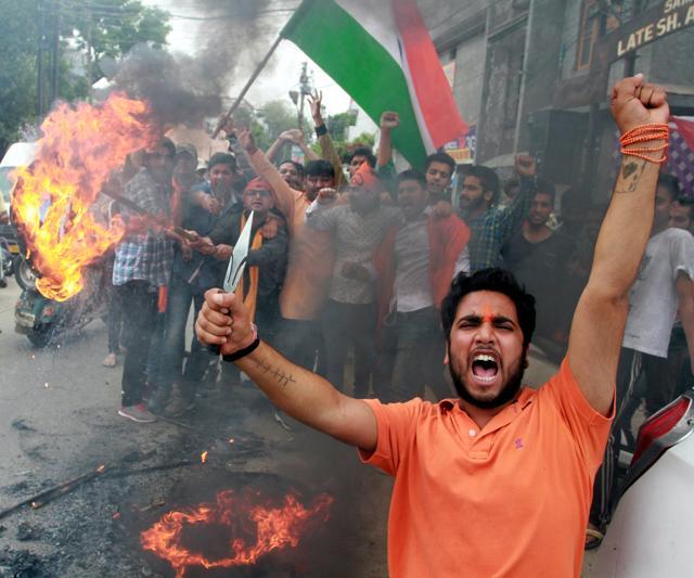 Activists of Vishav Hindu Parishad burning tyres during a protest against ongoing unrest at the National Institute of Technology (NIT) Srinagar in Jammu on April 6. (Nitin Kanotra/HT Photo) Activists of Vishav Hindu Parishad burning tyres during a protest against ongoing unrest at the National Institute of Technology (NIT) Srinagar in Jammu on April 6. (Nitin Kanotra/HT Photo)