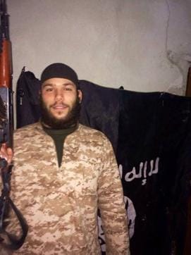 A pictures of Swedish national Osama Krayem holding what appears to be an AK-47 rifle and standing in front of an Islamic State flag. (Image courtesy: Swedish Media) A pictures of Swedish national Osama Krayem holding what appears to be an AK-47 rifle and standing in front of an Islamic State flag. (Image courtesy: Swedish Media)