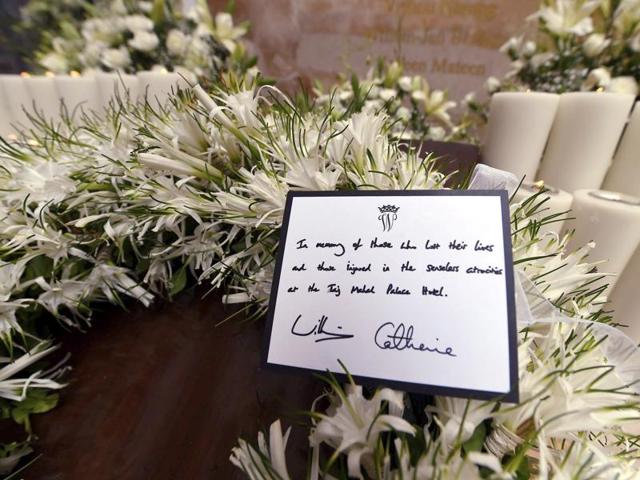 The card displaying the message on the wreath laid by the Prince William, and his wife, the former Kate Middleton on the martyrs memorial at the Taj Mahal Palace Hotel in Mumbai. (AP Photo) The card displaying the message on the wreath laid by the Prince William, and his wife, the former Kate Middleton on the martyrs memorial at the Taj Mahal Palace Hotel in Mumbai. (AP Photo)