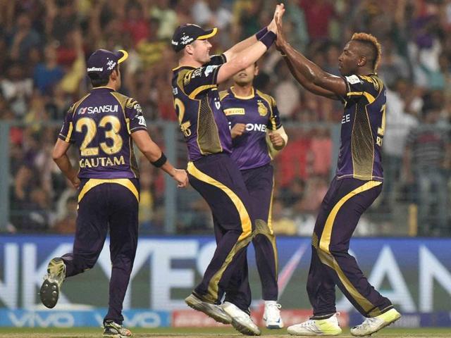 KKR bowler Andre Russell celebrate with team mates after taking a wicket. (PTI Photo)