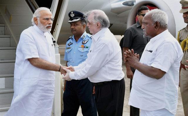 Prime Minister Narendra Modi being received by the Kerala governor Justice P Sathasivam and the minister of state for road transport and highways and shipping P Radhakrishnan(PTI) Prime Minister Narendra Modi being received by the Kerala governor Justice P Sathasivam and the minister of state for road transport and highways and shipping P Radhakrishnan(PTI)
