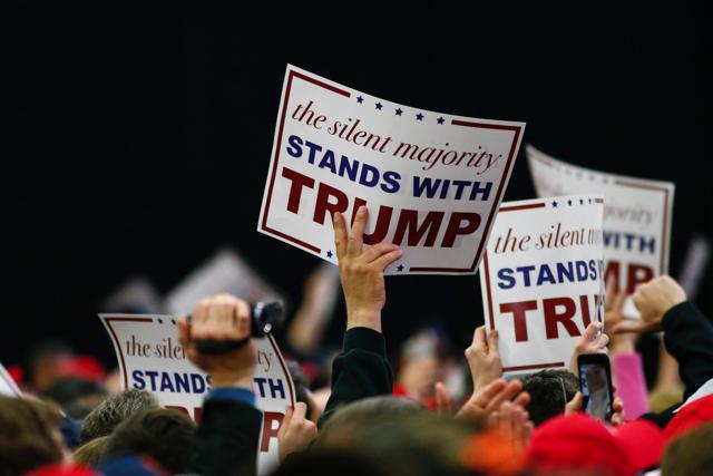 A major section of the Americans support Trump for his proposed policies against migrants, Muslims and Mexicans in US, which otherwise may not be openly accepted by many. A placard from one of his rallies speaks the same. (AFP) A major section of the Americans support Trump for his proposed policies against migrants, Muslims and Mexicans in US, which otherwise may not be openly accepted by many. A placard from one of his rallies speaks the same. (AFP)